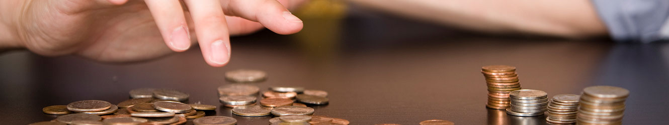 Man moving coins around and stacking them.