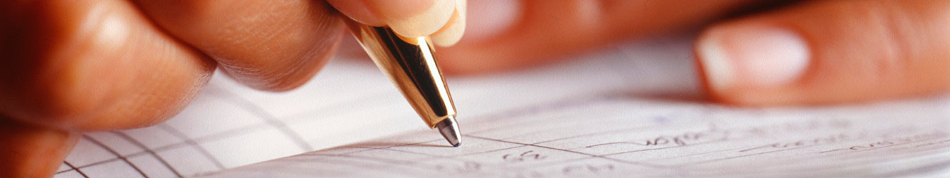 Close up of woman recording entries in checkbook register.